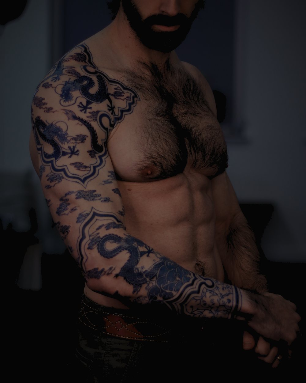 SAKI’s work — a cobalt-blue dragon across the arm and chest